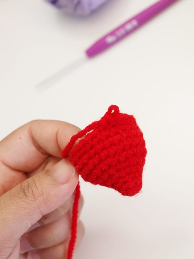 Adorable crochet strawberry bag charm pattern for keychains, purses, and backpacks.